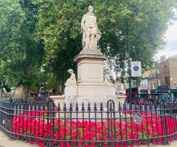 Islington Green Statue on Islington green surrounded by flowers